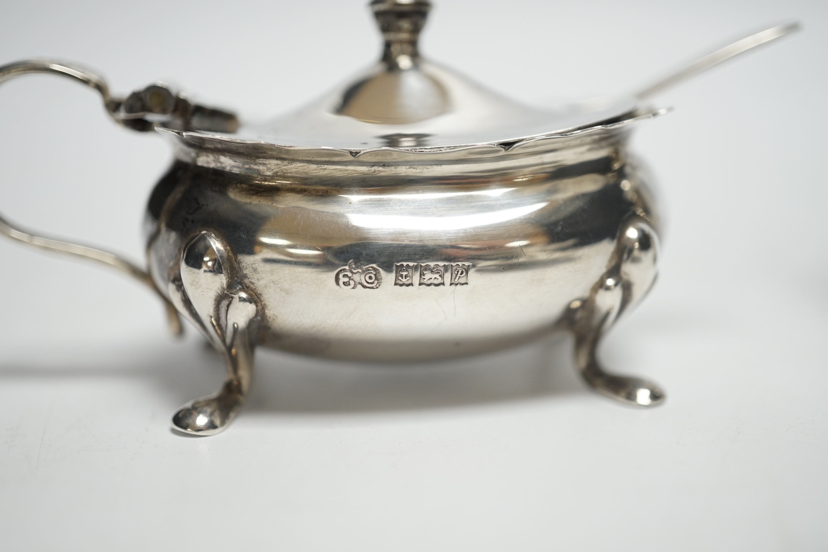 A Elizabeth II three piece silver condiment set by Elkington & Co, Birmingham, 1964/65, with associated silver spoon.